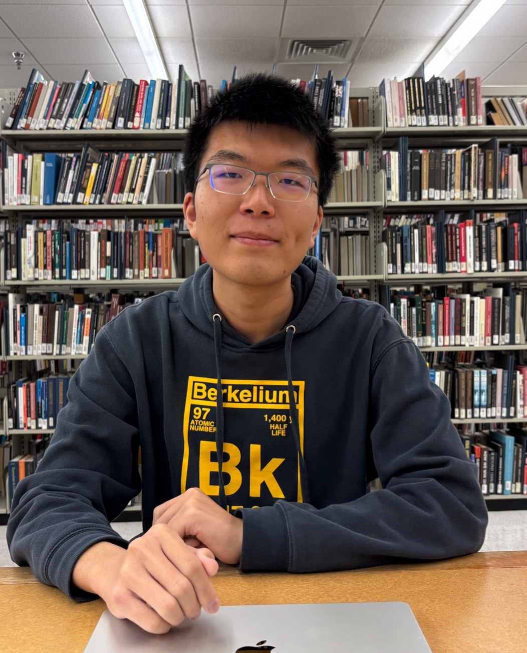A photo of Kaiyue sitting in a library.